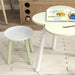 Kids table and chair set with green flower-shaped table and white round chair