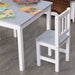 Grey and white kids table and chair set with books on tabletop, on wooden floor