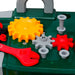 Kids toy workbench with colorful plastic gears, bolts, and a red wrench on green surface