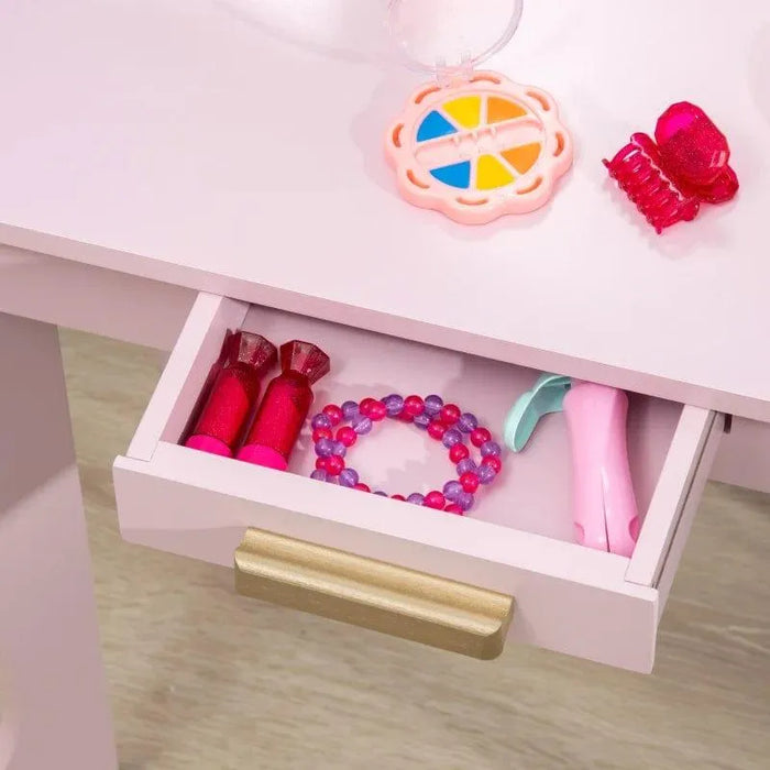 Kids vanity table drawer with pink toy makeup, hair clip, bracelet and compact