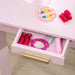 Kids vanity table drawer with pink toy makeup, hair clip, bracelet and compact