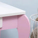 Close-up of pink and white kids vanity table corner with curved leg and drawer