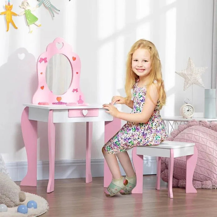 Smiling girl at pink and white kids vanity table with mirror and storage in bright bedroom