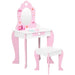 Pink and white kids vanity table with mirror, matching stool, and princess-themed accents.