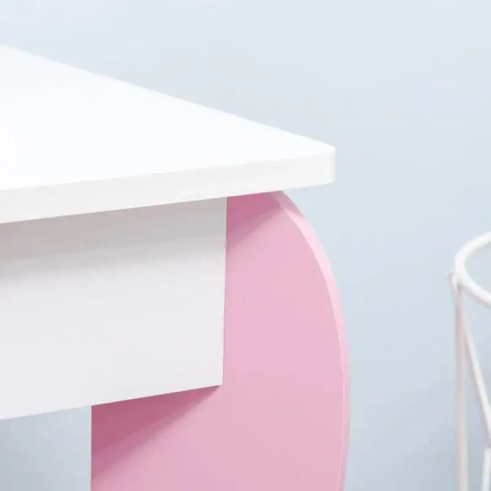 Kids vanity table with pink and white finish, rounded leg design, minimalist style