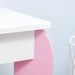 Kids vanity table with pink and white finish, rounded leg design, minimalist style