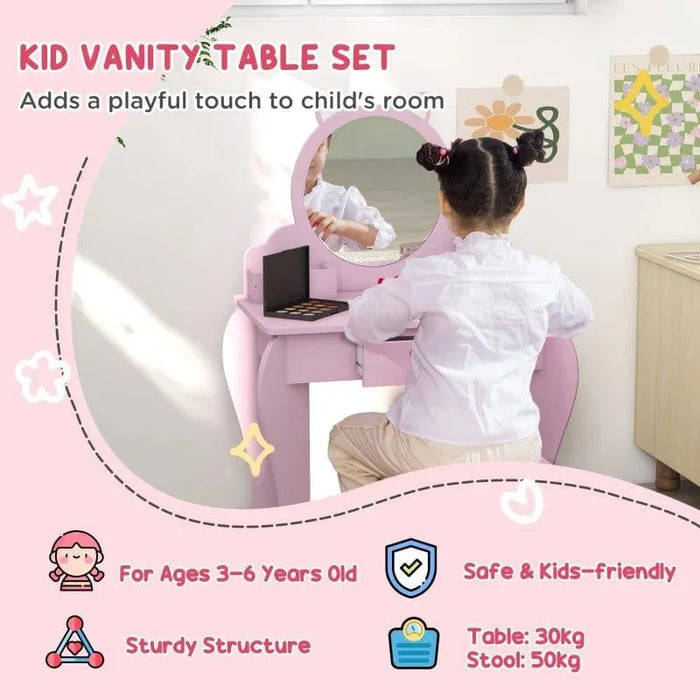 Child using pink kids vanity table set with cat-shaped mirror and matching stool in a bedroom