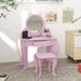 Pink kids vanity table set with cat-shaped mirror and matching stool in a child's room