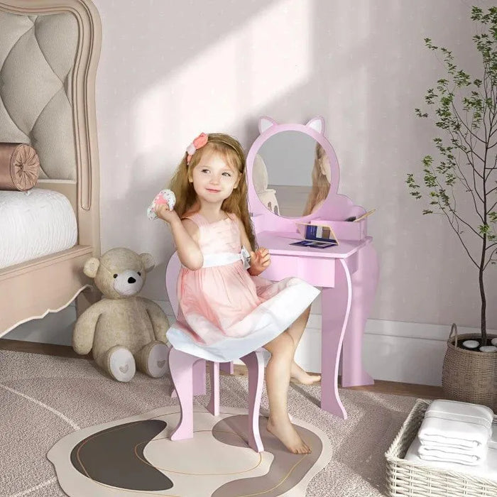 Girl using pink kids vanity table set with cat-shaped mirror and matching stool in bedroom