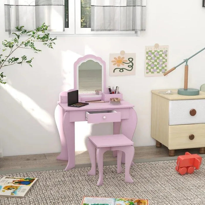 Pink kids vanity table set with mirror and stool in a bright children's bedroom