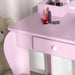 Pink kids vanity table set with drawer, lipstick, mascara, and teddy bear beside it