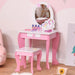 Kids pink vanity table set with unicorn design, oval mirror, and matching stool