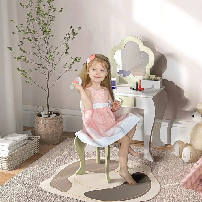 Girl at kids' vanity table set with flower mirror, green stool, and drawer in bedroom