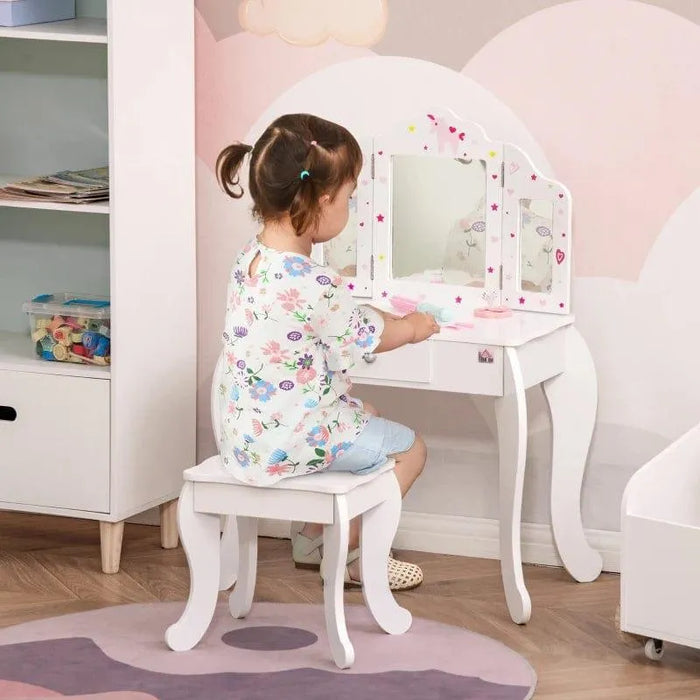 Child sitting at white kids vanity table set with triple mirror, stars and hearts design, and stool