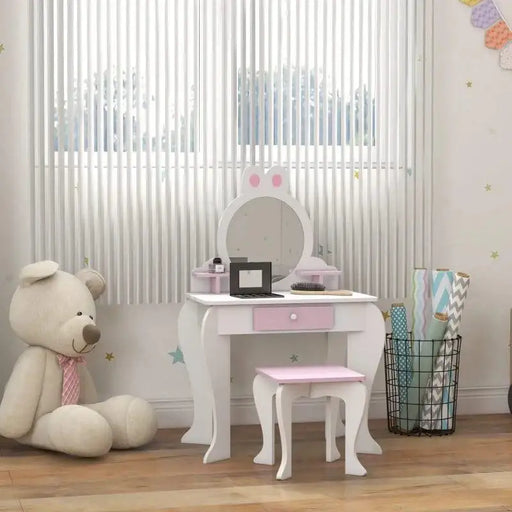 Kids white and pink vanity table with bunny ear mirror and matching stool in playroom