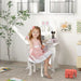 Girl at white and pink kids vanity table with bunny stool, mirror, and drawer in bright room