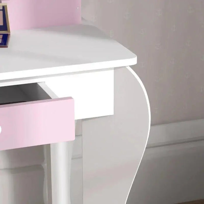 White kids vanity table with pink drawer and curved legs in a child's room