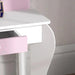White kids vanity table with pink drawer and curved legs in a child's room