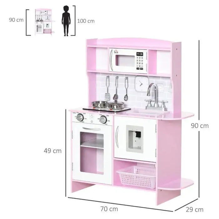 Pink and white wooden kids kitchen playset with oven, sink, storage, utensils, and clock.