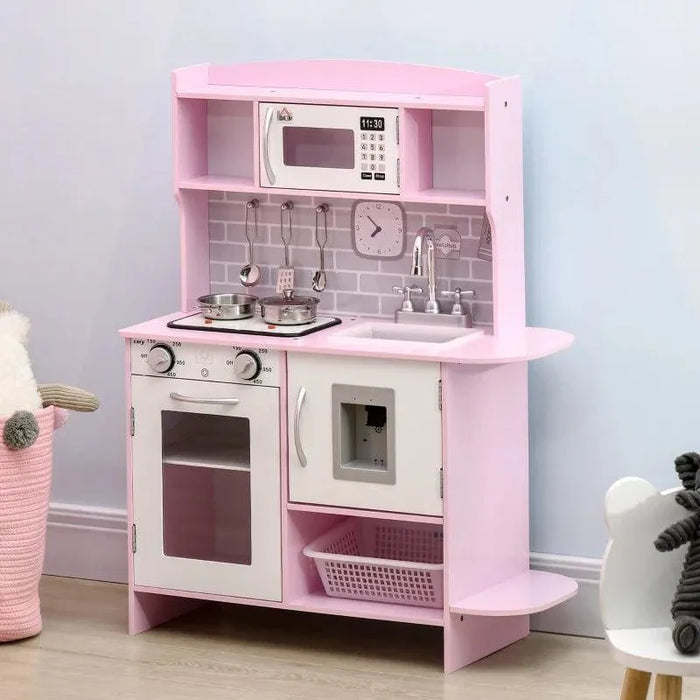 Pink and white kids wooden kitchen playset with toy oven, microwave, sink, and storage shelves