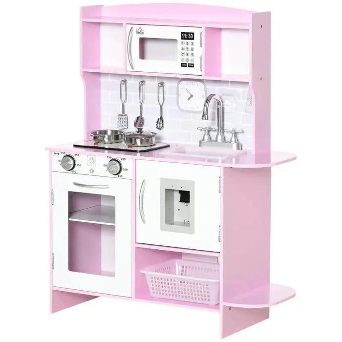 Pink wooden kids kitchen playset with toy stove, sink, clock, microwave, utensils, and storage