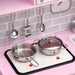 Kids pink wooden kitchen playset with toy pots, utensils, clock, and stovetop.