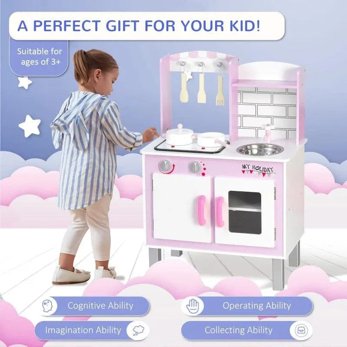 Girl playing with pink wooden kids kitchen playset featuring pots, pans, and utensils.