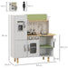 Kids wooden kitchen playset in white and green with refrigerator, stove, and sink, 84x34x89 cm.