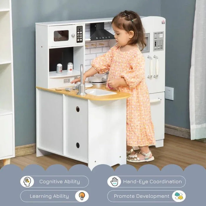 Child playing with white wooden kids kitchen playset featuring accessories and sink