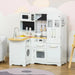 White wooden kids kitchen playset with sink, stove, oven, microwave, and accessories.