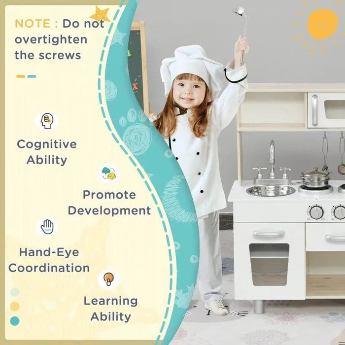 Child in chef costume with kids white wooden kitchen playset and stainless steel accessories