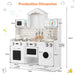 White wooden kids pretend play kitchen with oven, microwave, sink, stove, and hanging utensils