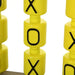 Close-up of yellow tic-tac-toe spinning blocks with black X and O letters