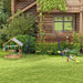Kids wooden sandbox with canopy, swing set, and seesaw in a garden beside a wooden house.