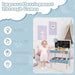 Toddler with kids wooden workbench and blue tool set, chalkboard, and clock in playroom