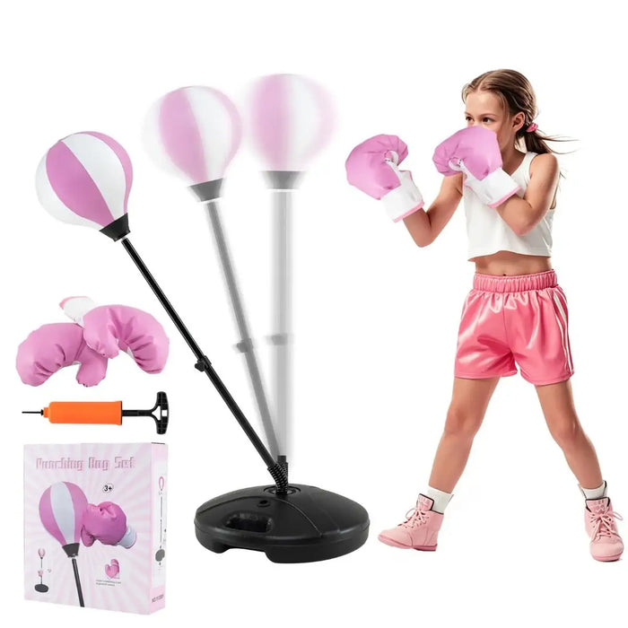Young girl in pink boxing gloves and shorts punching a pink and white reflex punching bag with stand