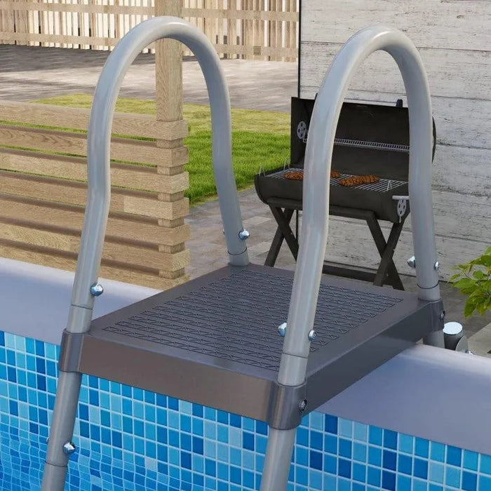 Grey steel frame above-ground pool with ladder and backyard barbecue grill