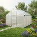 Large aluminum greenhouse with double-walled polycarbonate panels in a lush garden