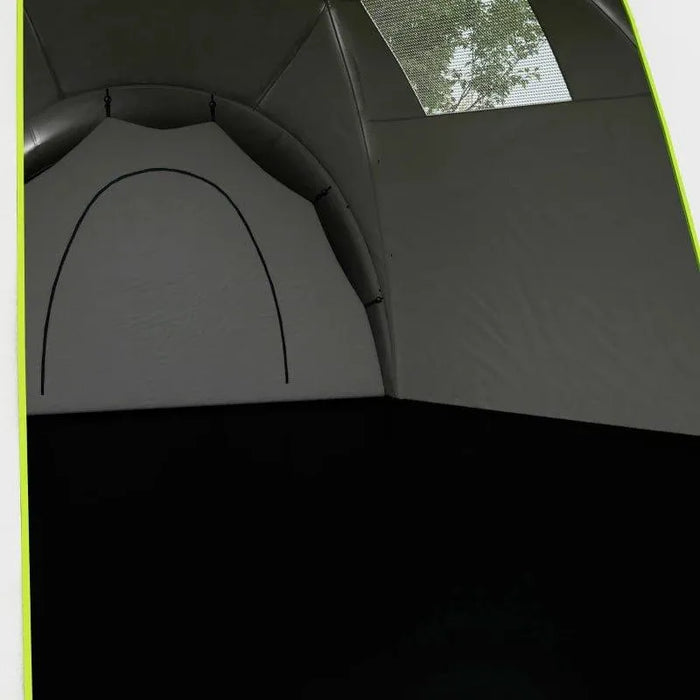 Interior view of large green camping tent with window and bedroom divider