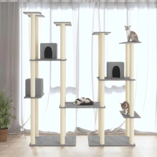Large light grey multi-level cat tree with three cats, scratching posts, and condos by window.