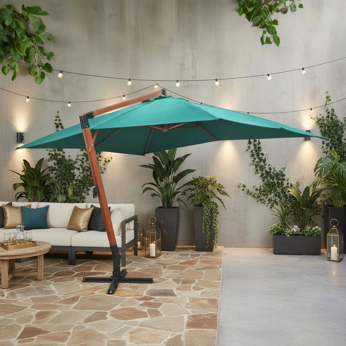 Large green floating parasol with wooden stand on stone patio, outdoor sofa and potted plants
