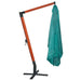 Large green parasol with wooden stand and closed canopy on metal base for outdoor shade