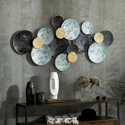 Decorative wall art with round, textured panels on a gray wall.