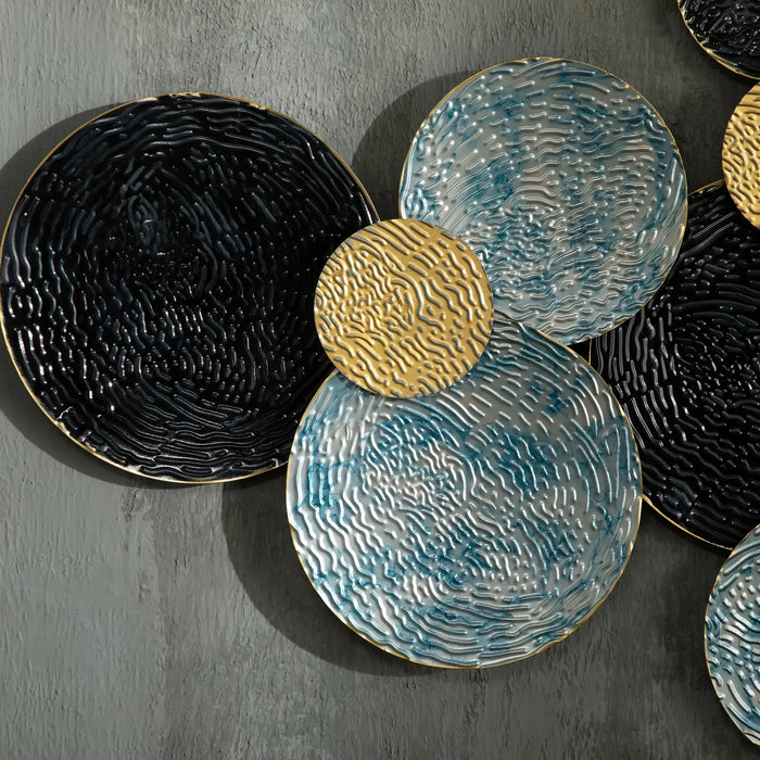 Set of decorative plates with textured surfaces on a gray background