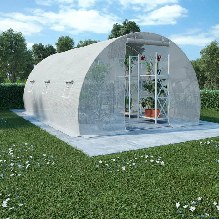 Large walk-in greenhouse polytunnel with mesh cover on lawn, shelving with plants inside