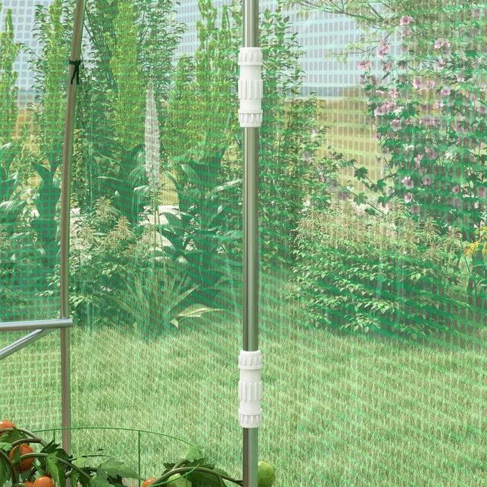 Inside view of walk-in polytunnel greenhouse with metal frame and green mesh walls