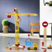 Large wooden yellow construction crane toy by Vilac with accessories and truck indoors