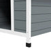 Grey wooden outdoor dog kennel with white frame and black leg cap