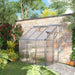Lean-to greenhouse 6x4ft with aluminium frame and sliding door against brick wall in garden