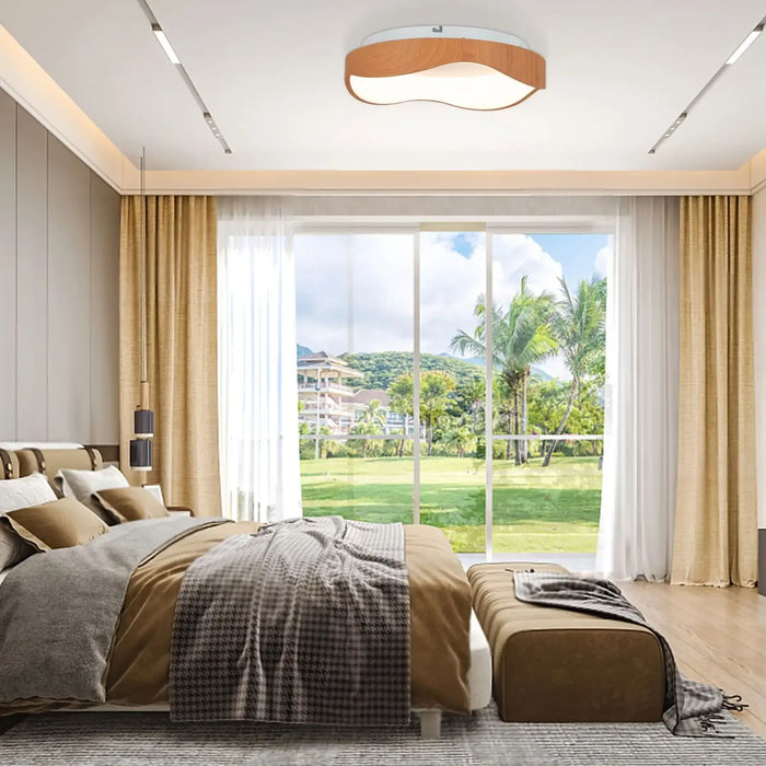 Modern bedroom with a large window view of greenery